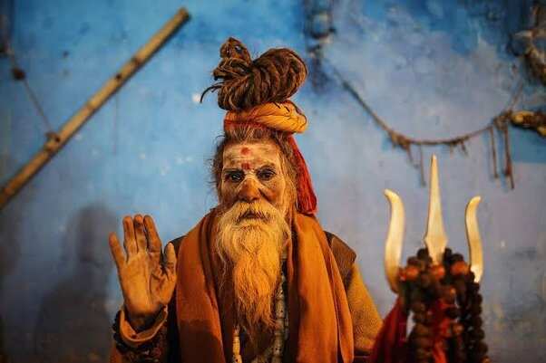 Why do sadhus and ascetics wear black saffron and white color clothes 